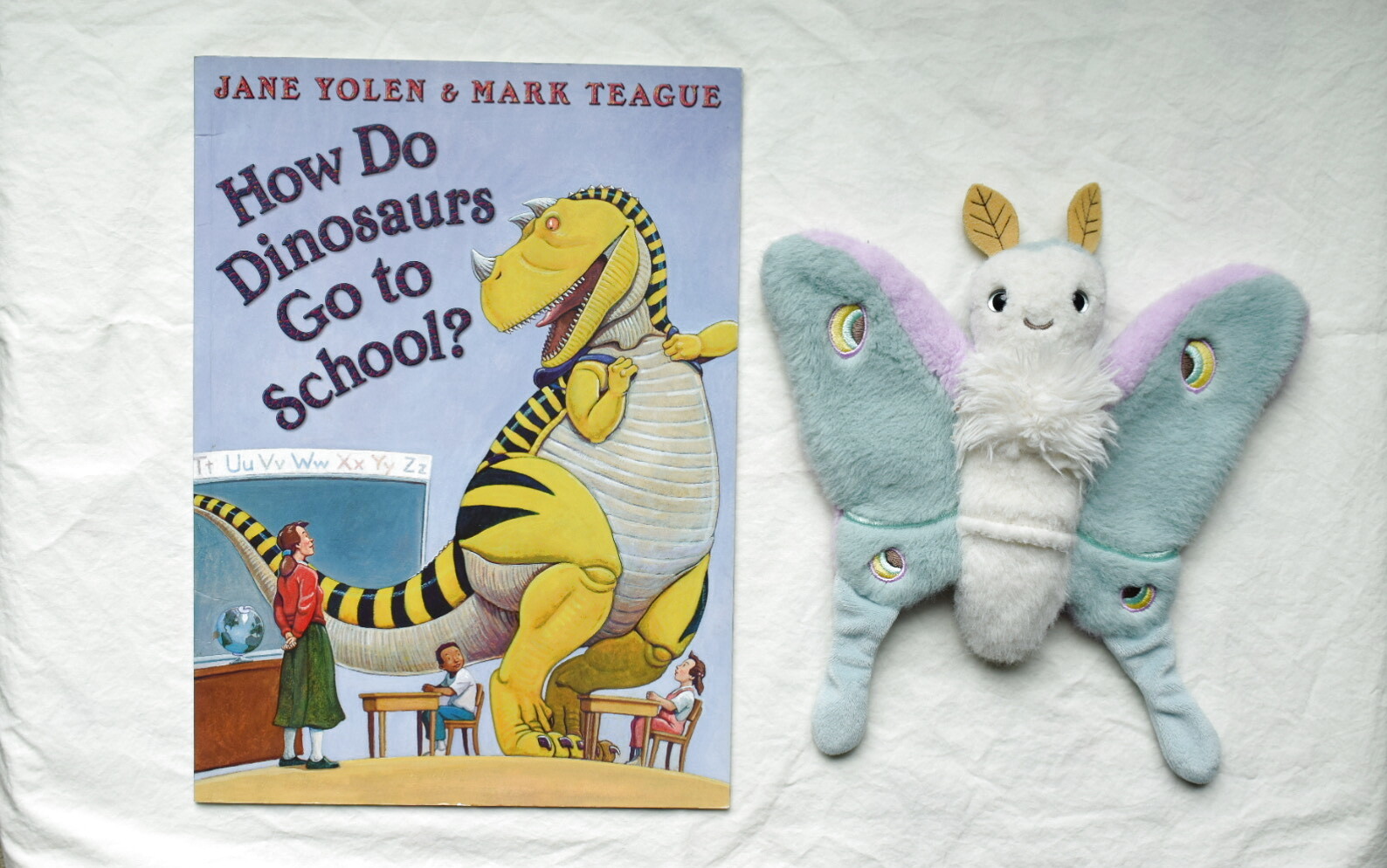 How Do Dinosaurs Go to School? next to Reference Moth, our resident size guide