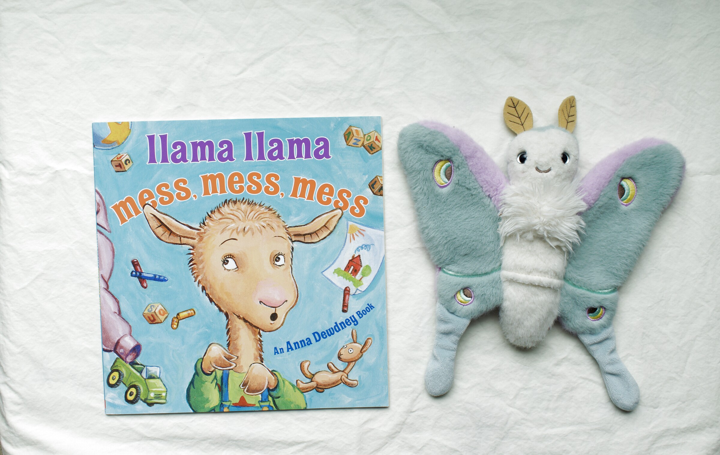 Llama Llama Mess, Mess, Mess next to Reference Moth, our resident size guide