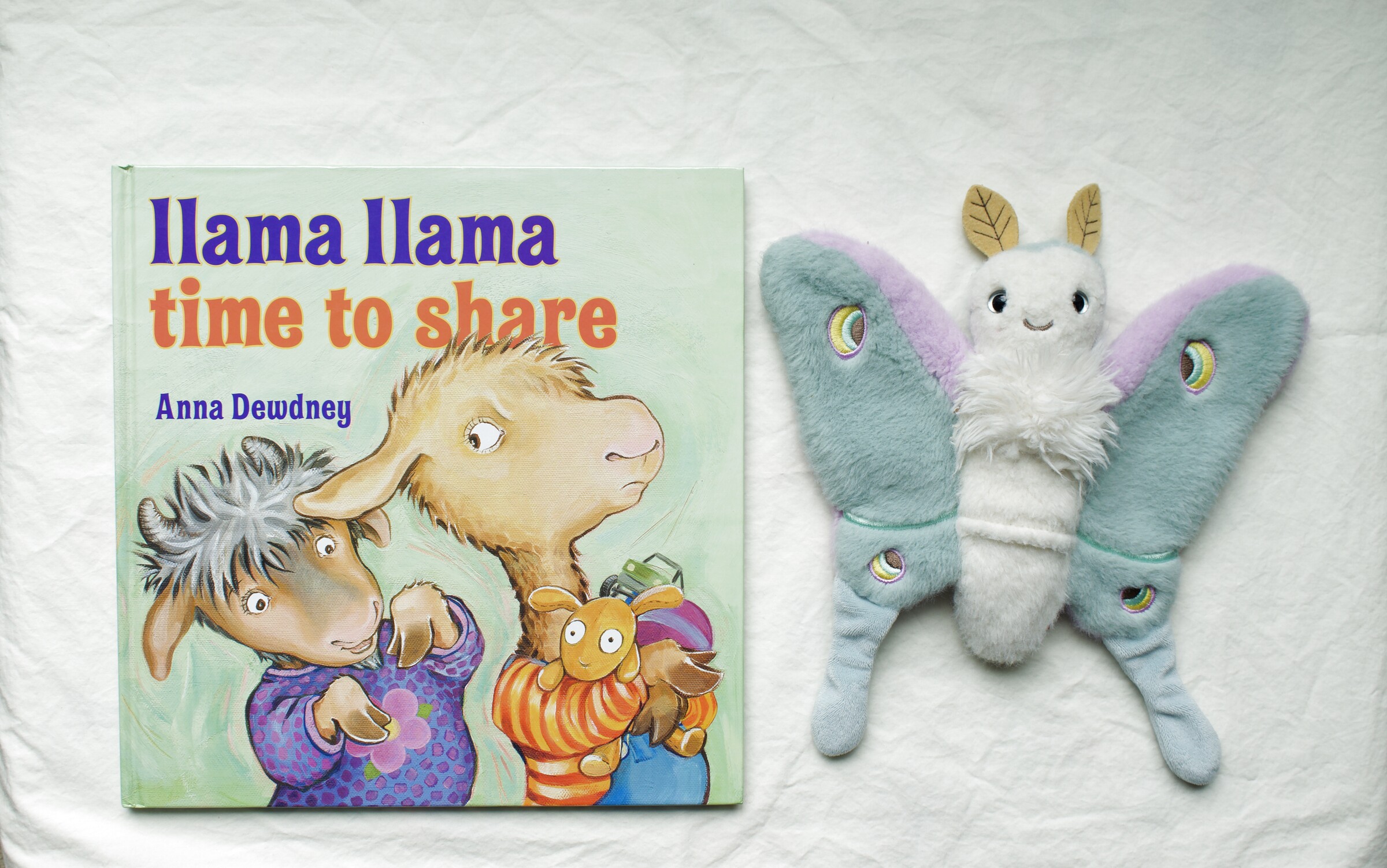 Llama Llama Time to Share next to Reference Moth, our resident size guide