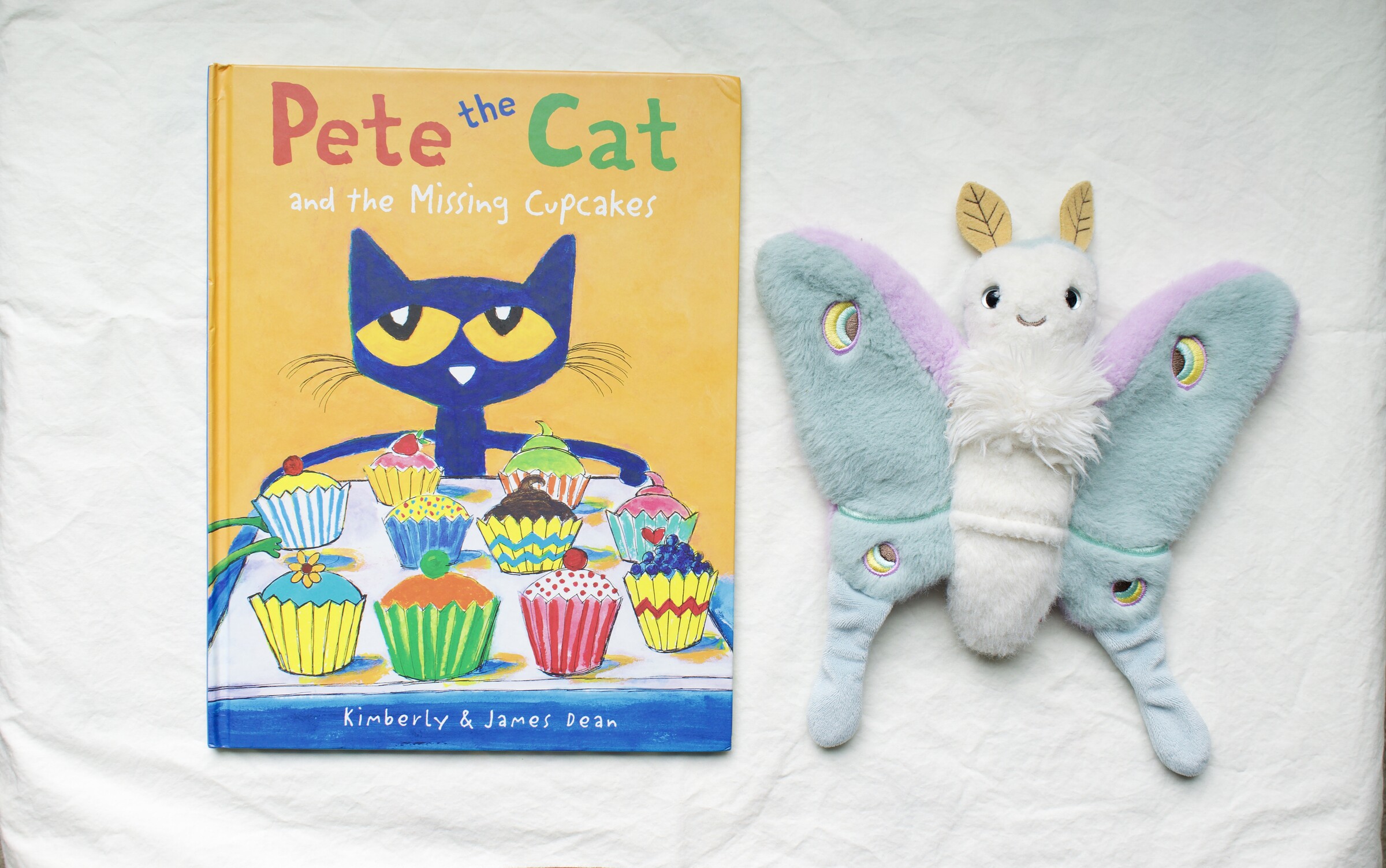 Pete the Cat and the Missing Cupcakes next to Reference Moth, our resident size guide